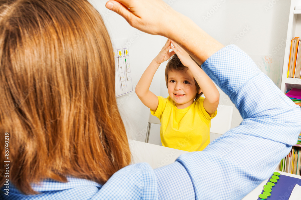 Boy putting hands together like therapist sitting