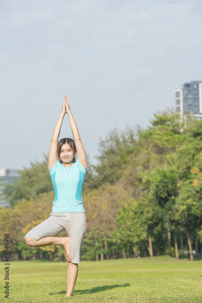 Asian woman make yoga call Tree Pose