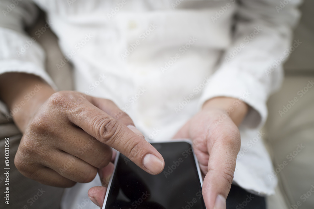 Businessmen are using a mobile phone sitting on the sofa