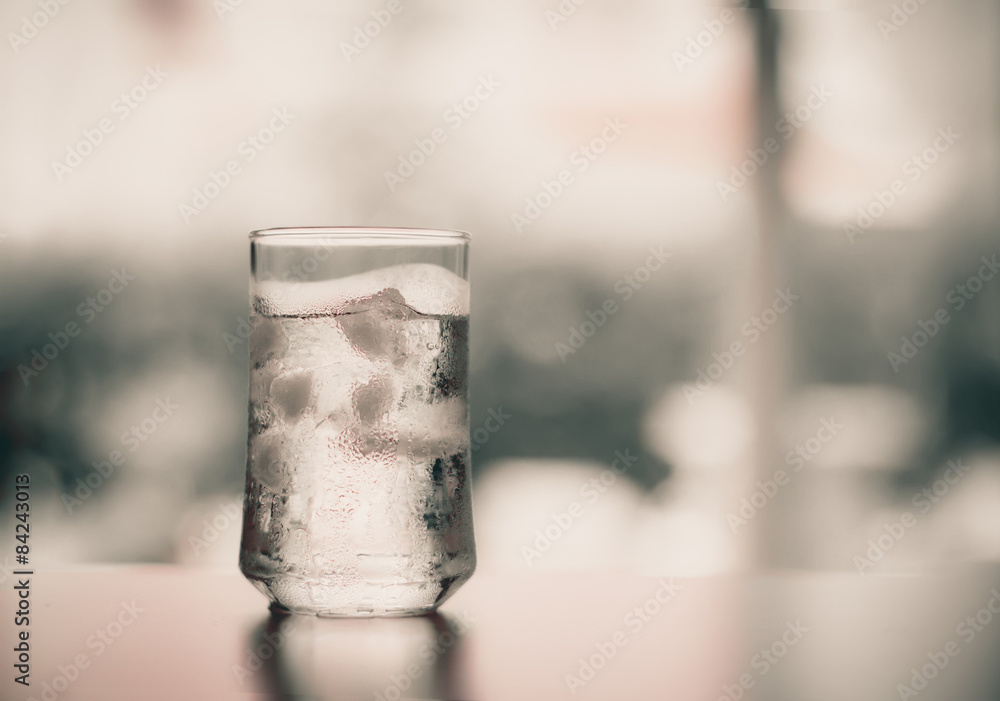 glass of Cool fresh drink with ice cube on the  table