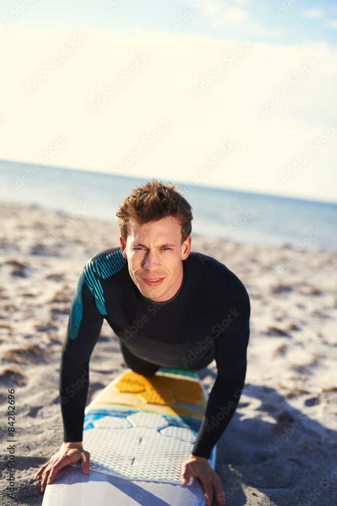 Male Surfer Showing How to Pop Up on Surfboard