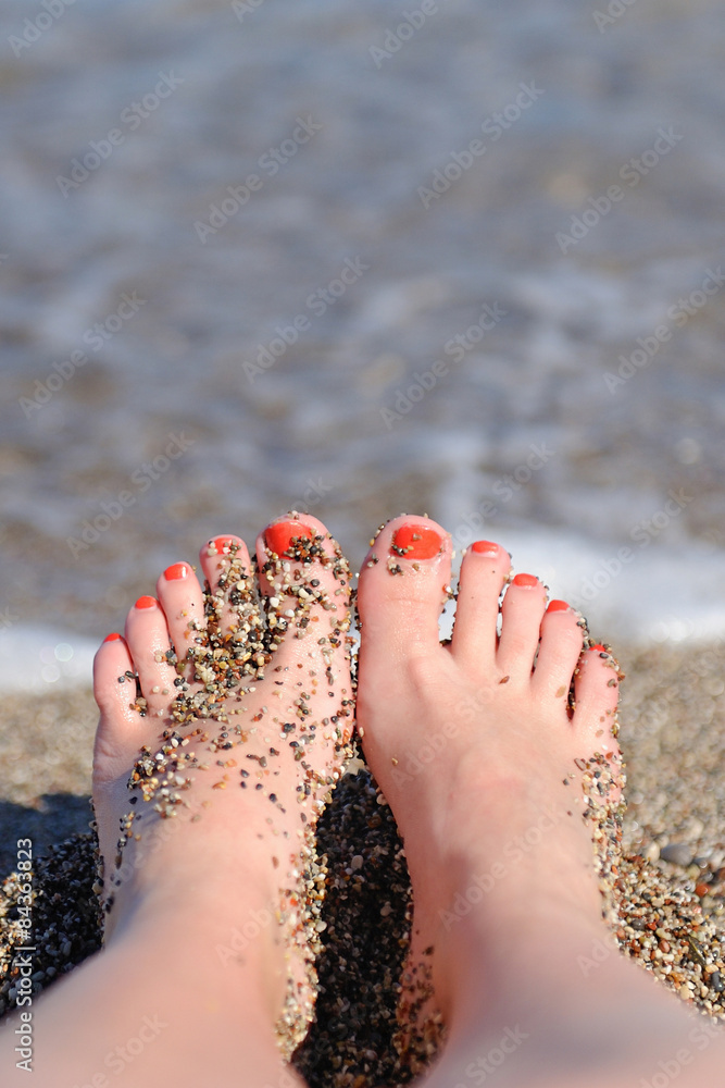 Woman feet closeup of girl relaxing on beach