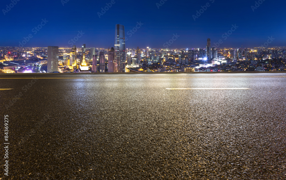 Empty road with modern city skyline