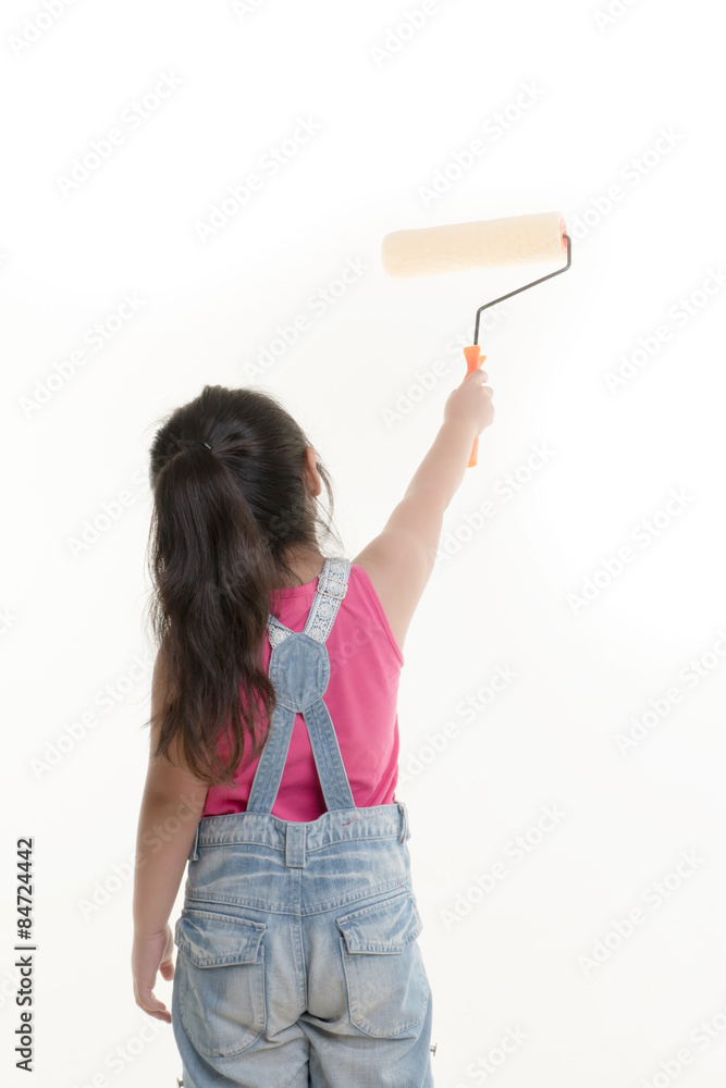 Little Asian child painting the wall on isolated back ground