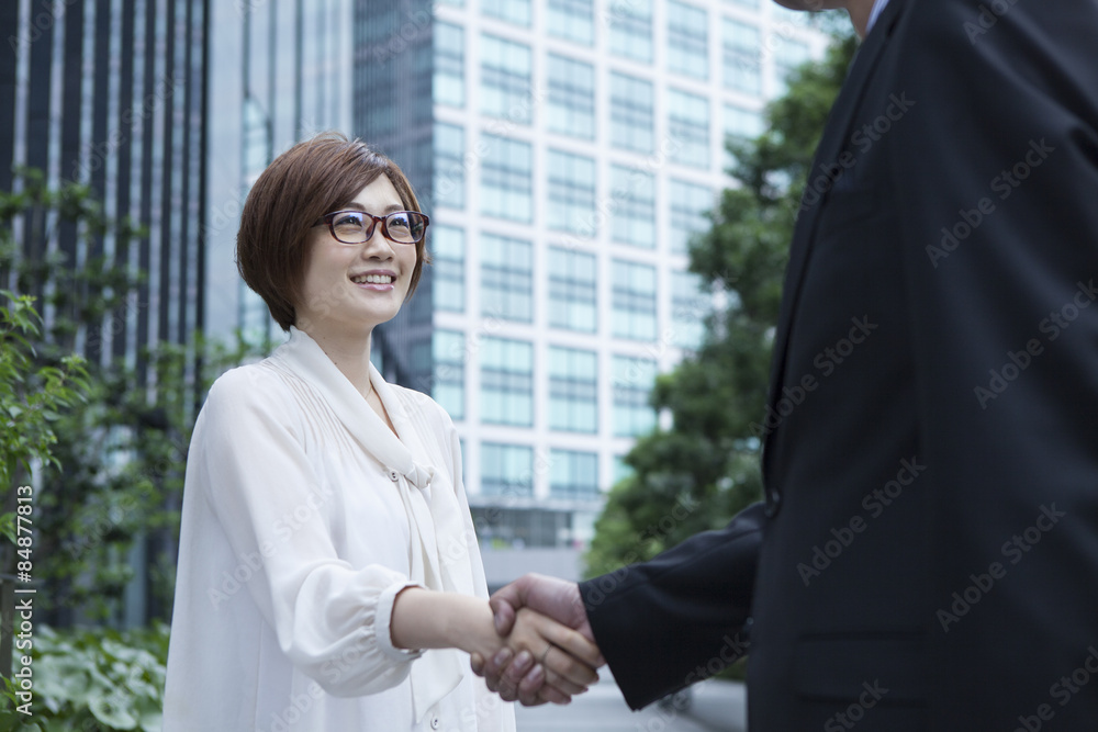 Men and women have a handshake in the office district