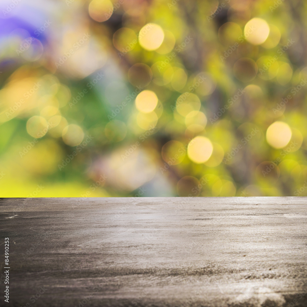 Fresh spring green grass with green bokeh and sunlight and wood