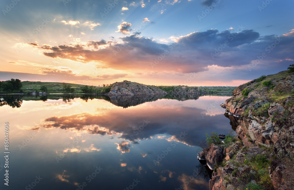 Beautiful summer sunset at the river with colorful sky