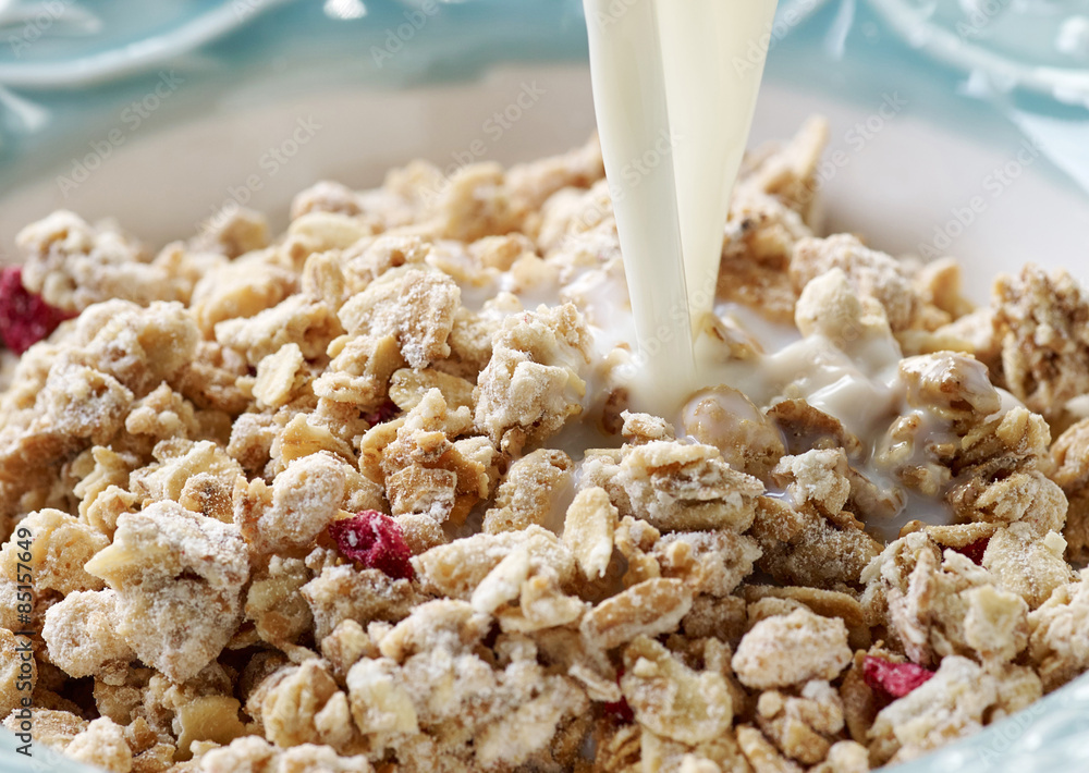 pouring milk into bowl of muesli