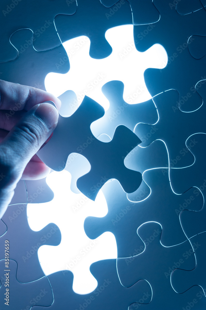 Hand insert jigsaw, conceptual image of business strategy, decis