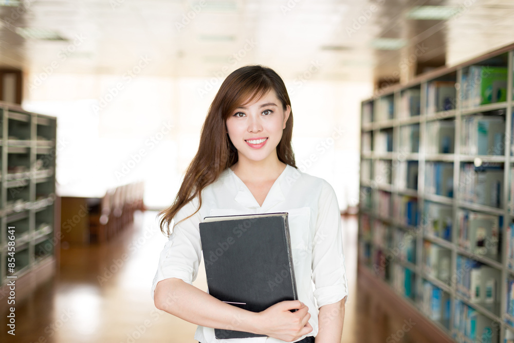 亚洲美女女学生在图书馆拿书