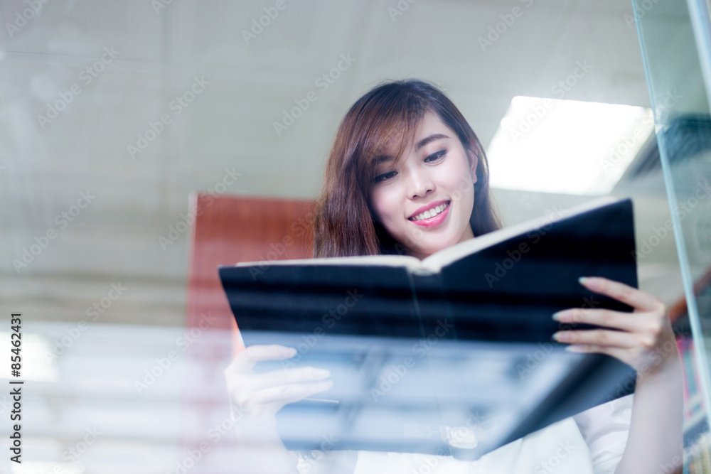 亚洲美女女学生在图书馆拿书