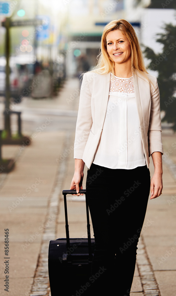 Professional woman posing for picture on the sidewalk