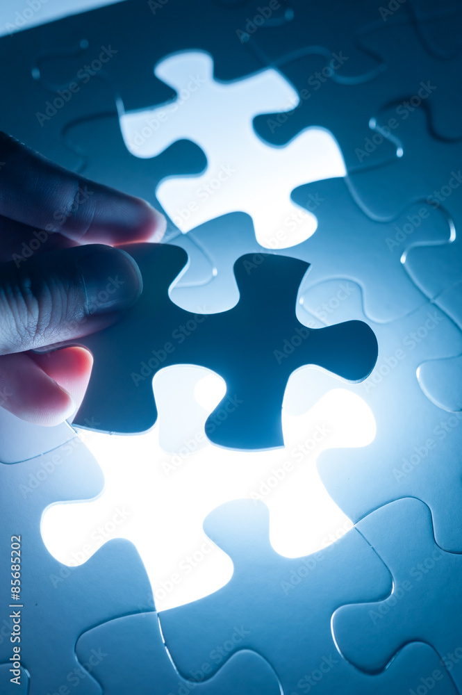 Hand insert jigsaw, conceptual image of business strategy, decis