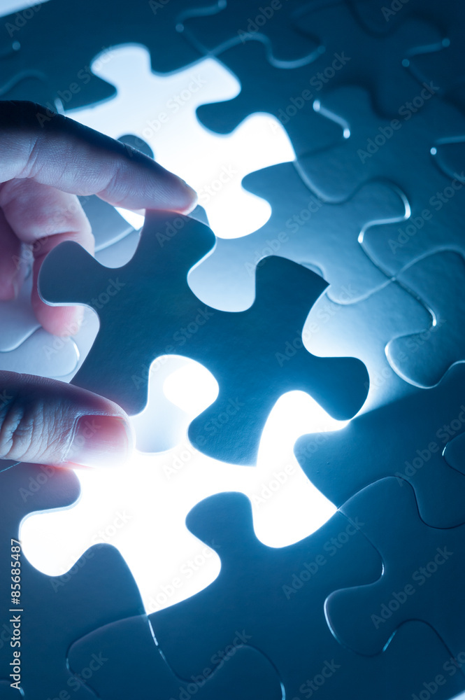 Hand insert jigsaw, conceptual image of business strategy, decis