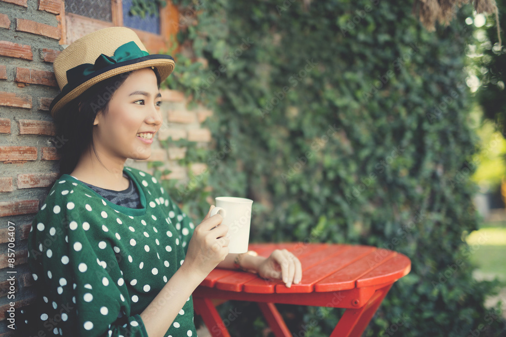 Asian woman drinking coffee Vintage color