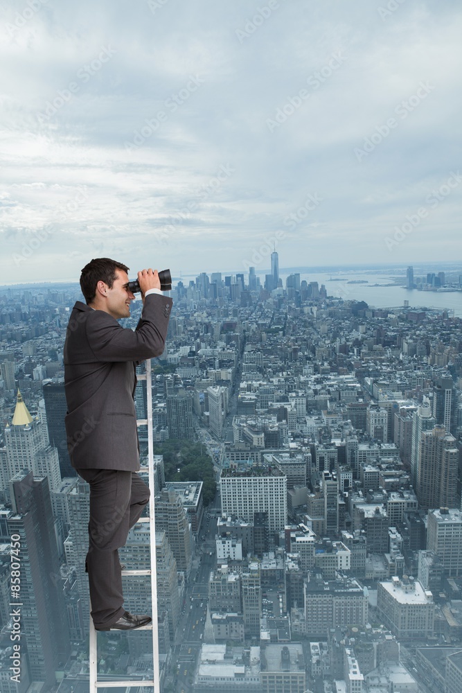 Composite image of businessman standing on ladder