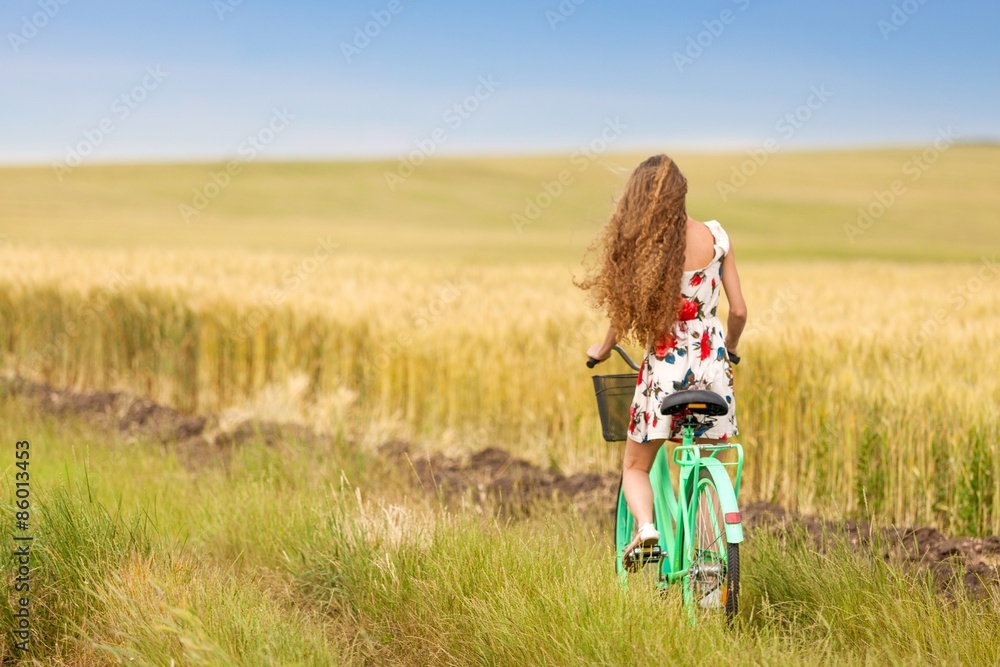 Girl, bike, green.