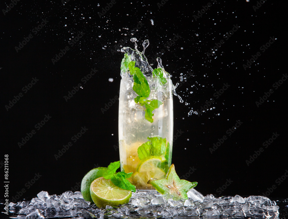 Mojito drink with splash on black background