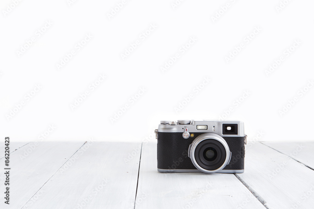 Retro style digital camera on wooden background