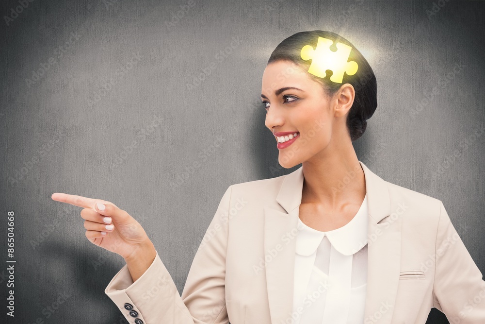 Composite image of smiling businesswoman pointing 