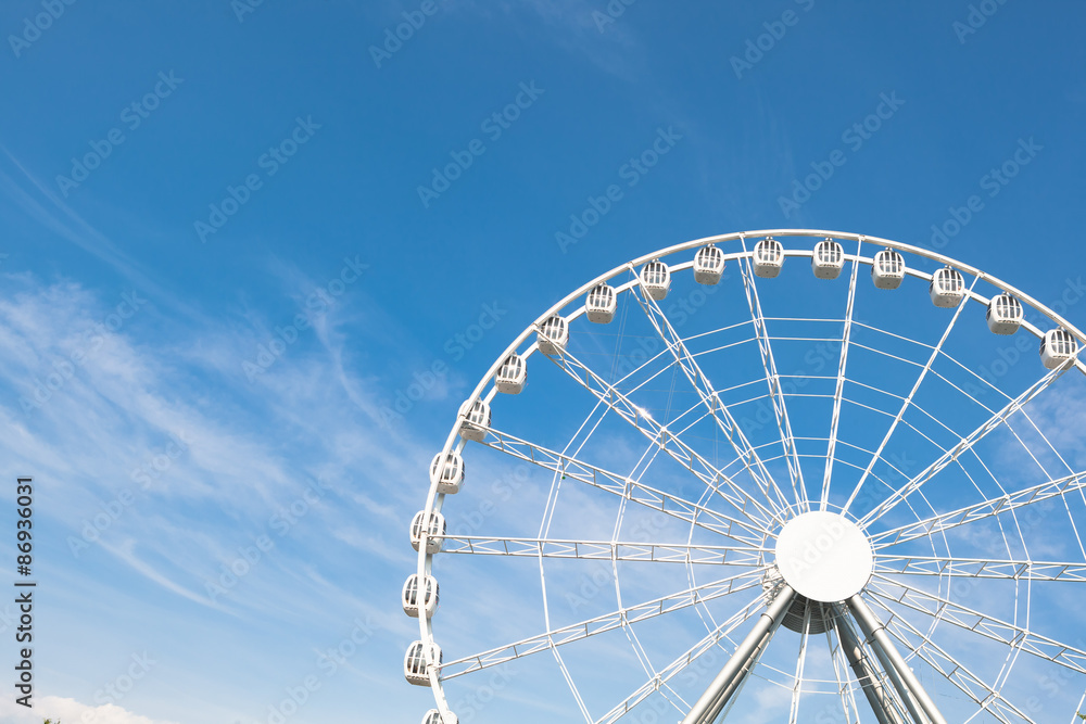 white ferris wheel against blue sky background