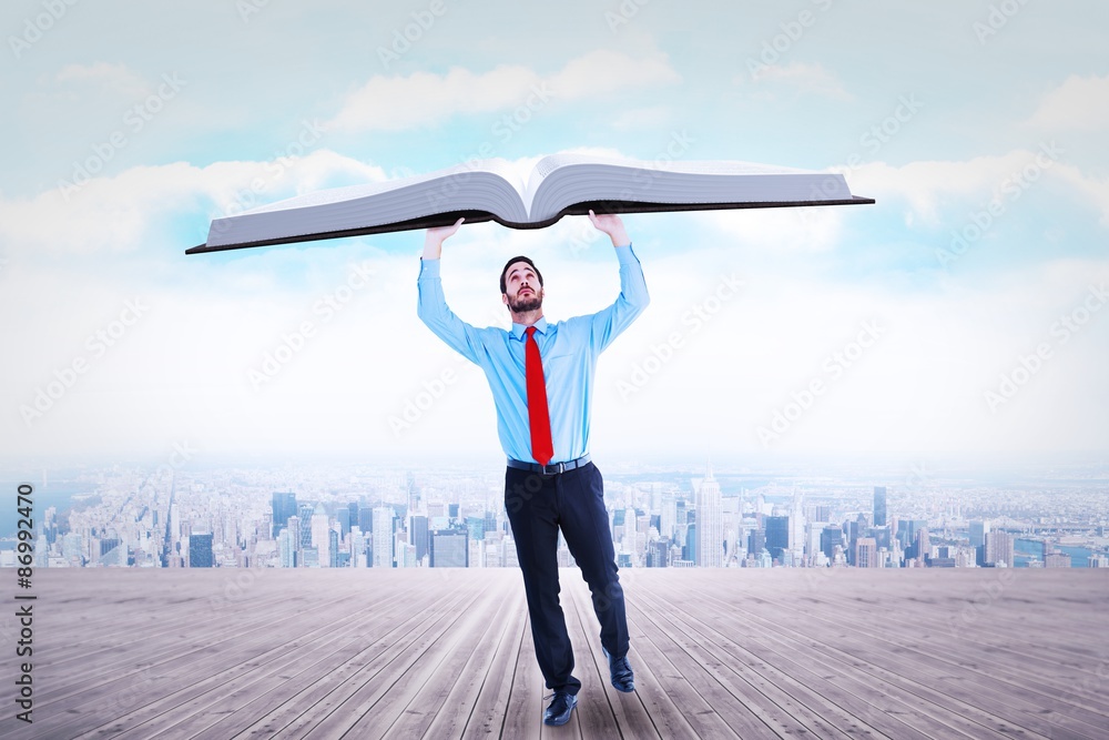 Composite image of businessman in suit pushing up with effort