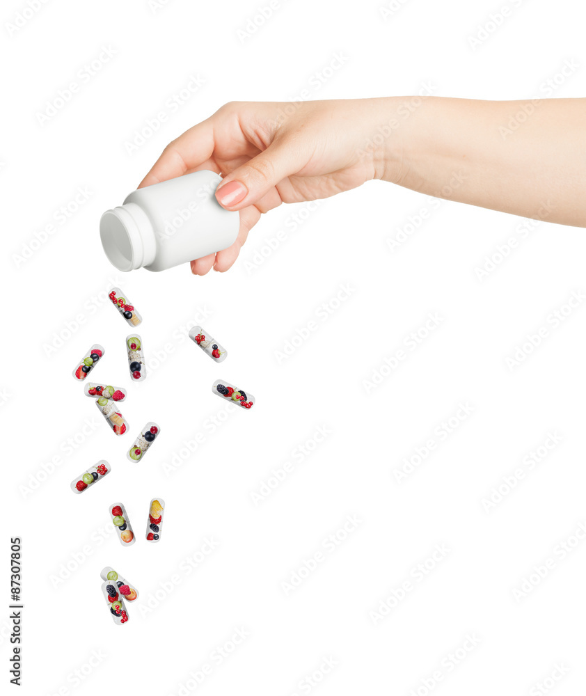 Medical capsule with berries flying out of the bottle