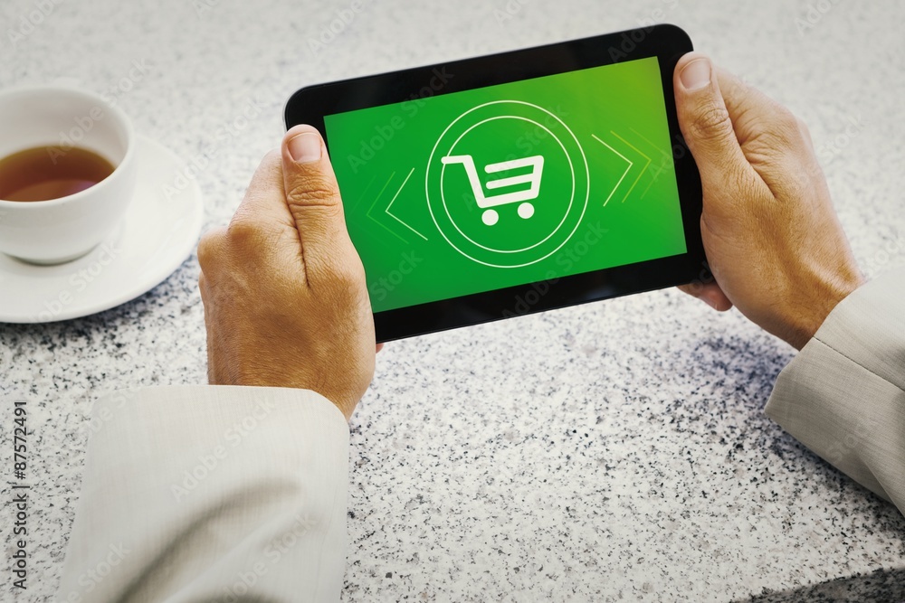 Composite image of businessman holding small tablet at table