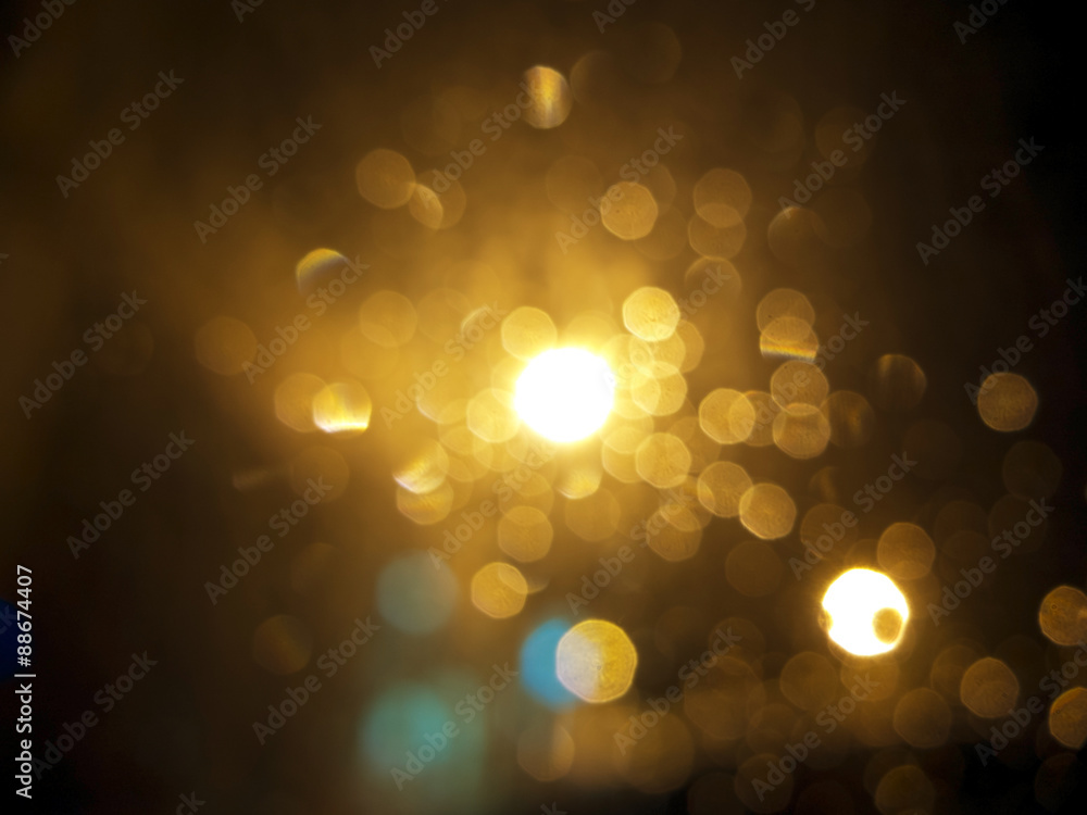 abstract black background, gold bubble lights or snowflakes falling at night. Bokeh Christmas backgr