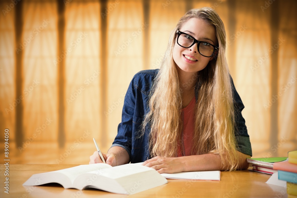 Composite image of student studying in the library 