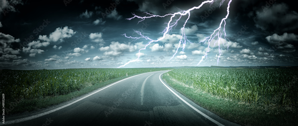 Panoramic landscape with thunderstorm over country road