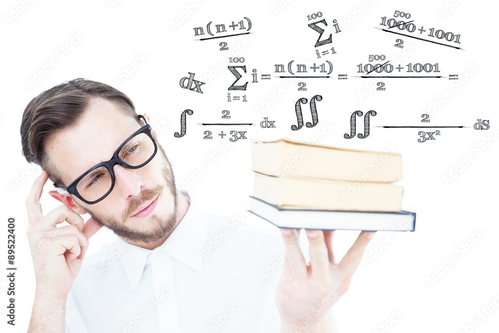 Composite image of geeky young man looking at pile of books