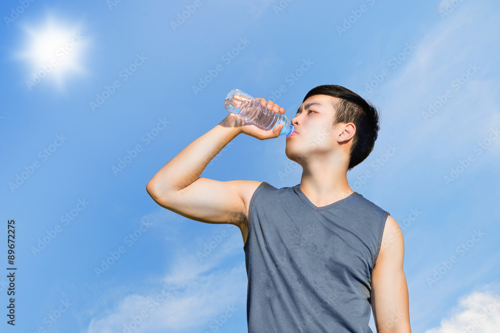 Sport and healthy concept : Thirsty athlete drinking water after