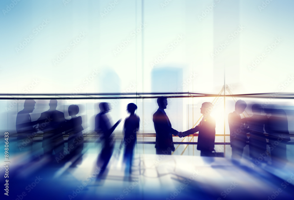 Silhouettes of Business People Meeting Handshake Concept