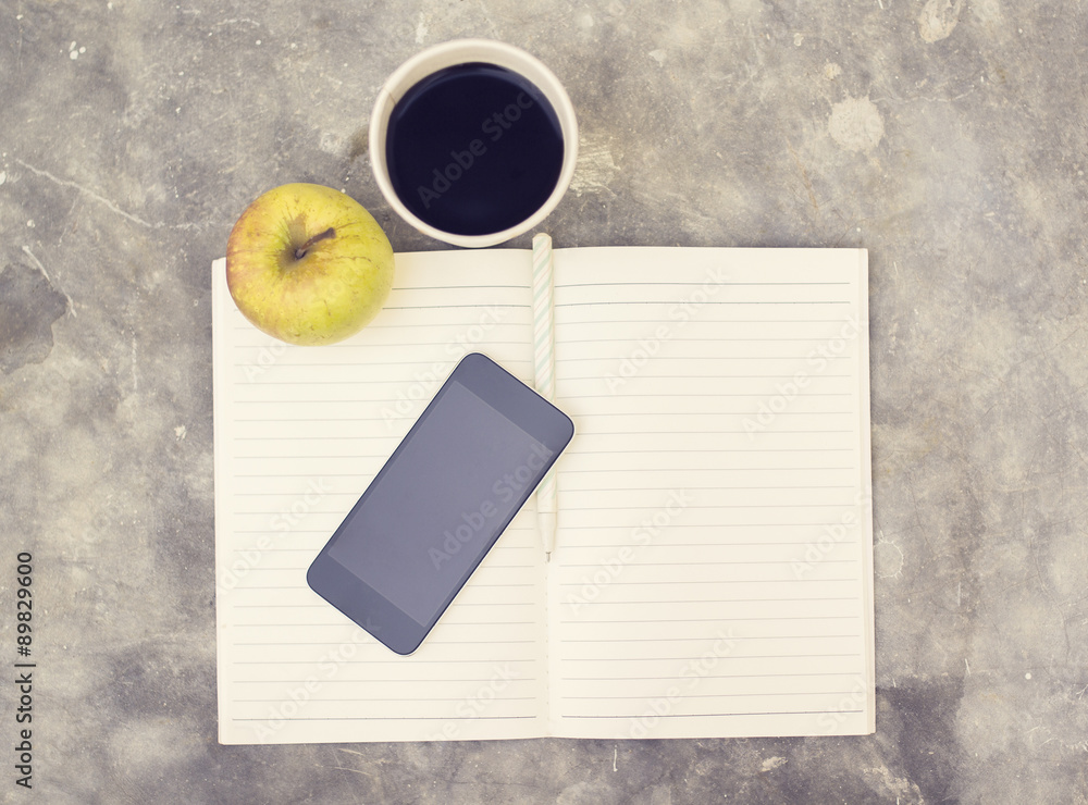 Blank cell phone, diary and cup of coffee