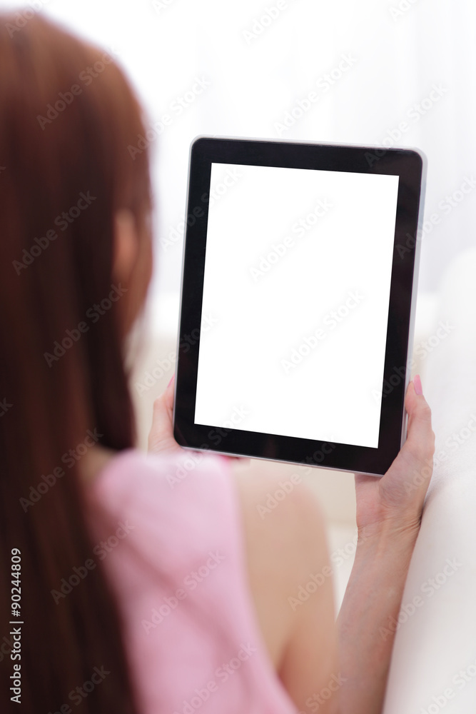 happy woman using tablet pc on sofa