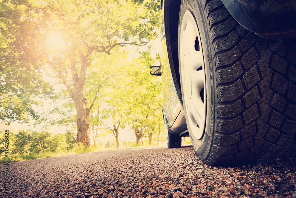 Car on asphalt road in summer