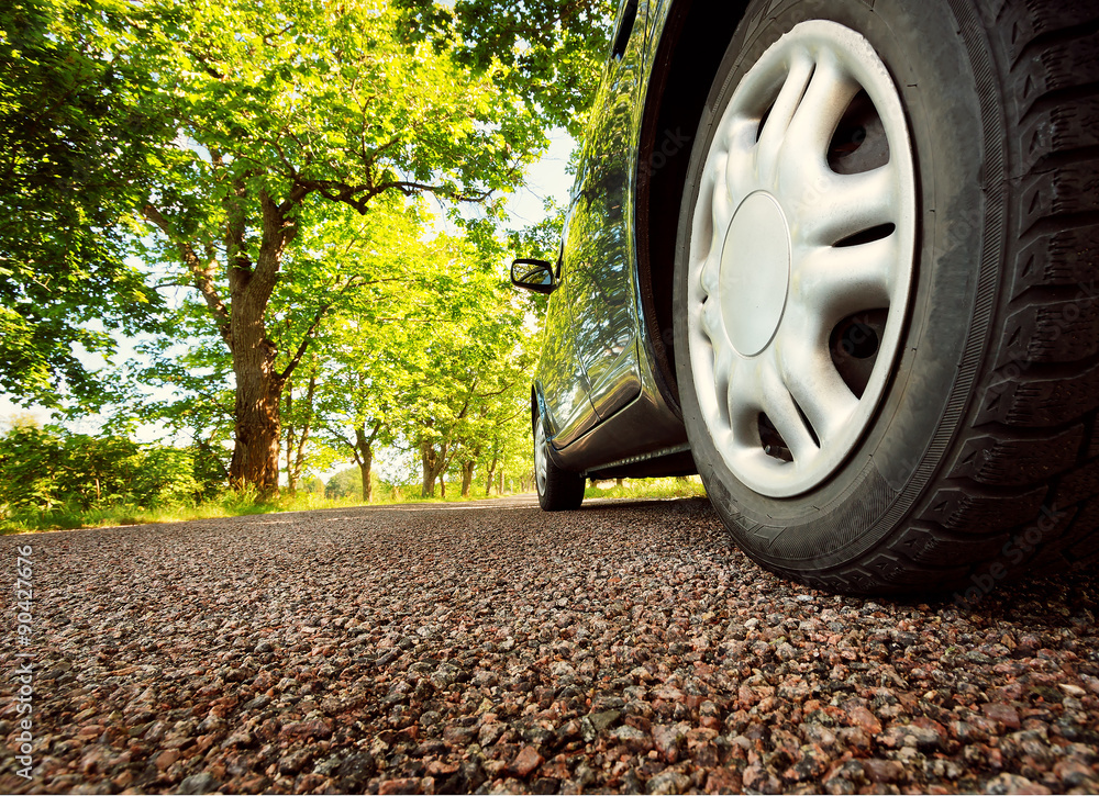 Car on asphalt road in summer