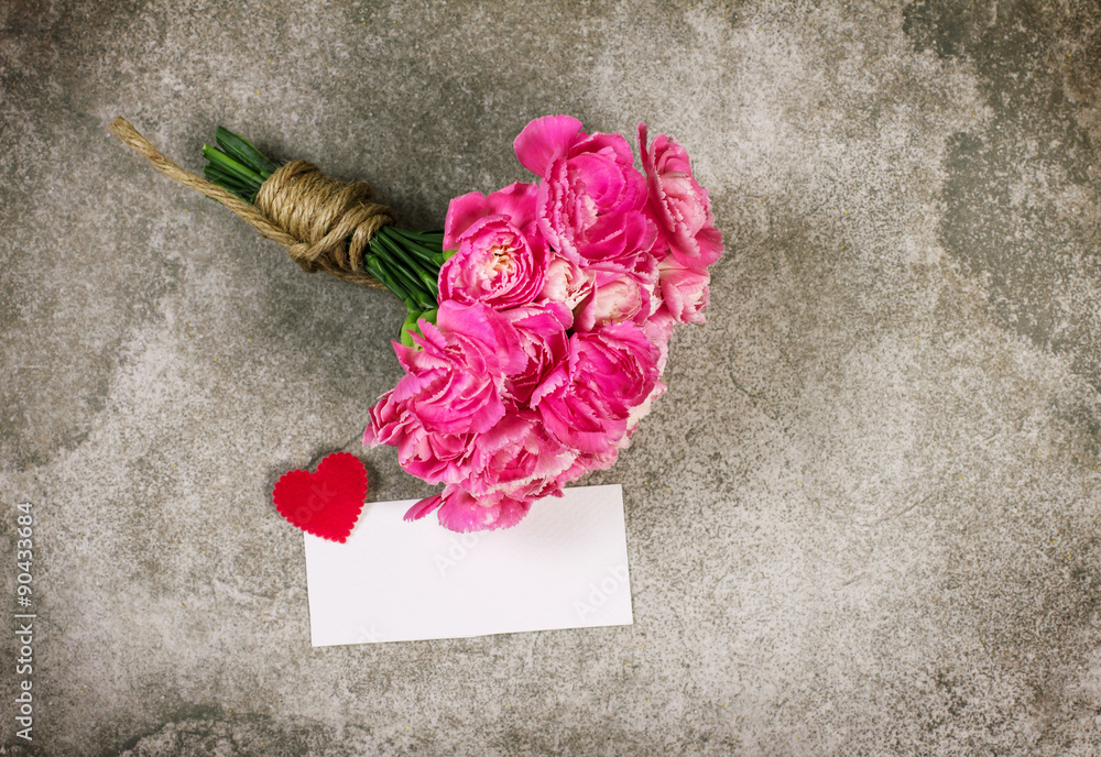 Fresh pink carnation flower and blank card for copy space over s