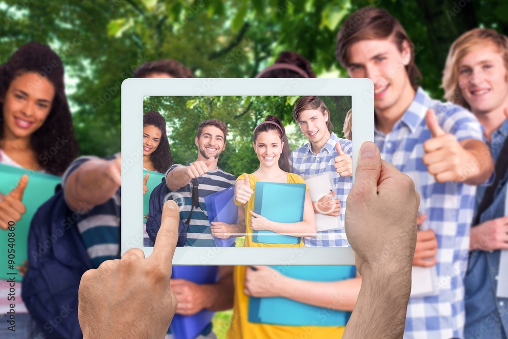 Composite image of hand holding tablet pc