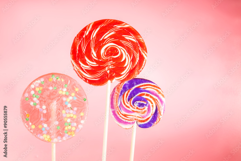 Giant spiral lollipops on a pink background