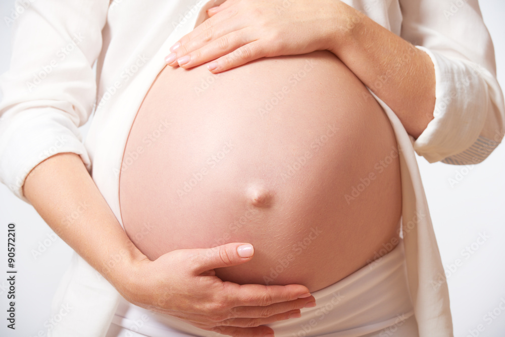 belly tummy of  pregnant woman on white background