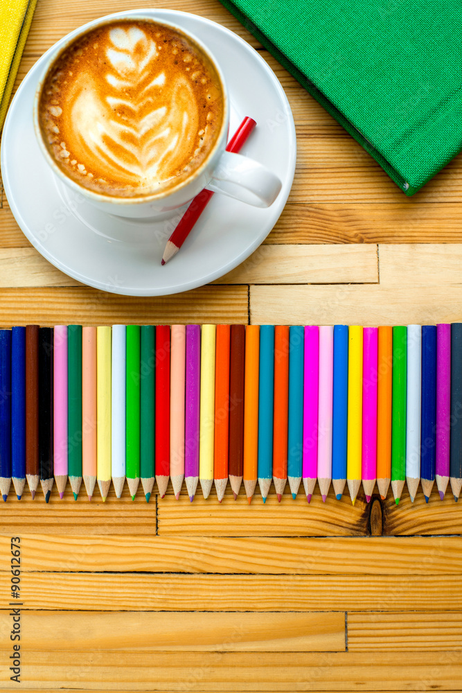 Colorful pencils with books and coffee