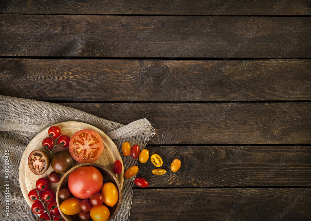 colorful tomatoes on a wooden table. top view