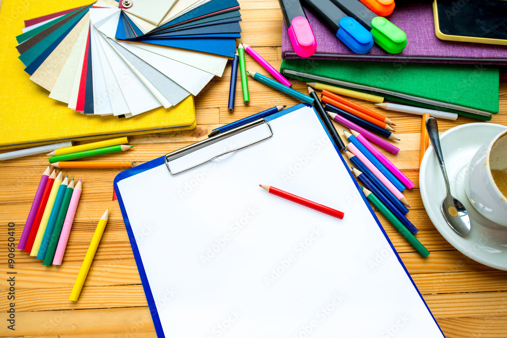 White sheet of paper with colorful samples and books 