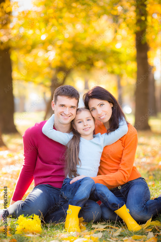 Happy family in autumn park