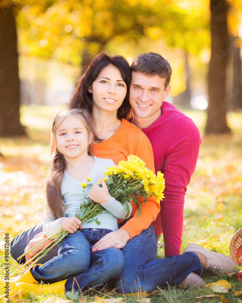 Happy family in autumn park