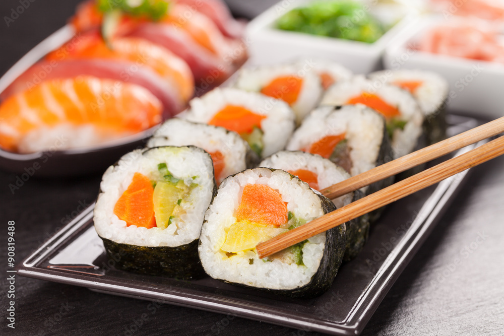 sushi pieces with chopsticks