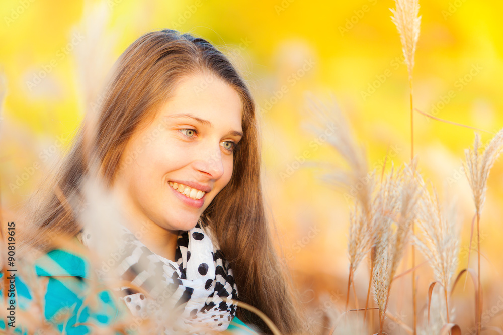 Beautiful girl lying in dry grass