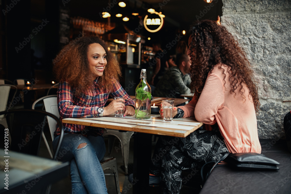 Two women sitting in a cafe talking